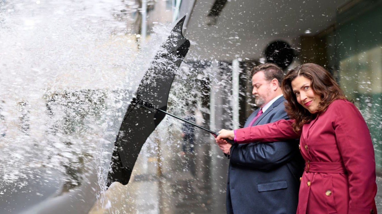 A lady with a broken leg sitting on the lounge with her kids.