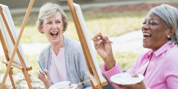 Photo of two elderly females painting