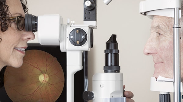 Slit lamp check: Man getting his eyes tested by an optometrist