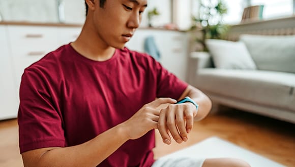 Person checking their blood pressure wearable
