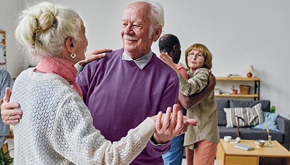 Older people dancing joyfully in an act of human connection