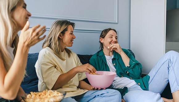 Group of women eating popcorn