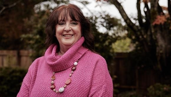 Portrait of Janet in a pink jumper