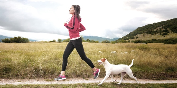 woman jogging with dog: Flip is on-demand injury insurance when you need it