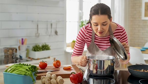 A woman cooking an easy meal on a budget
