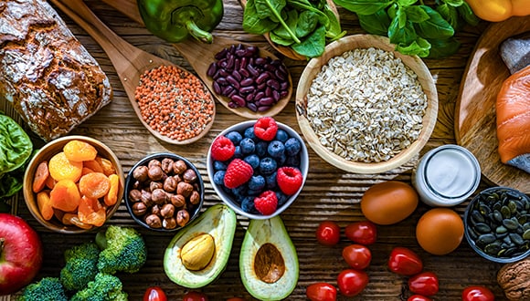 Different types of superfoods including dried fruits, nuts, eggs, avocados, beans and more
