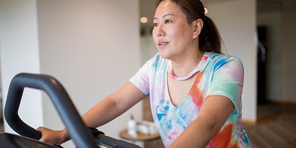 Woman looking sick with her head down as she tried to exercise