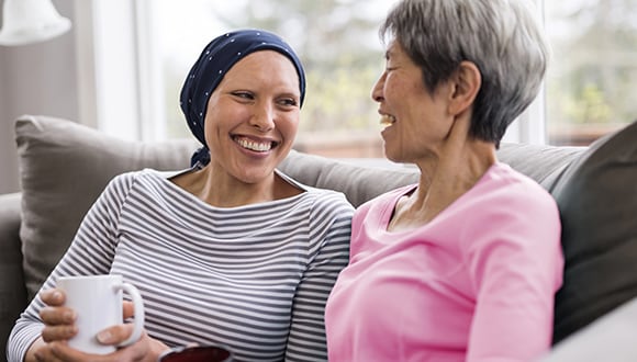 People sitting on a couch discussing the medical expenses PHI can cover