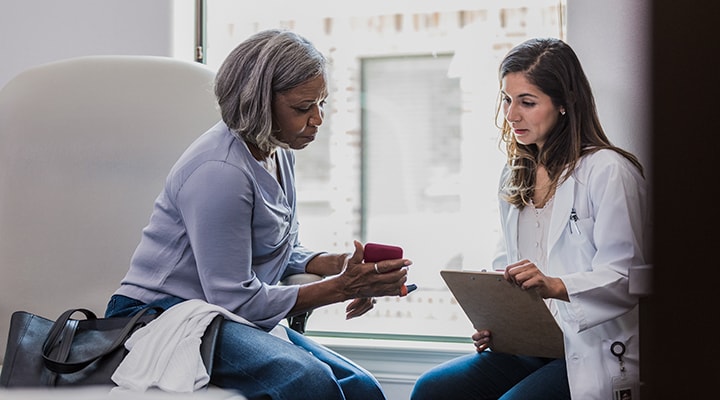 woman showing doctor her health records on app