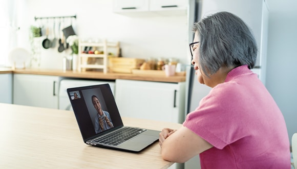 older women using a laptop for online therapy