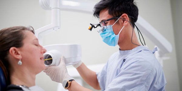 Dental health specialist examining a patient's oral health at the dental clinic