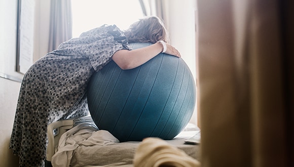 Pregnant woman stretching with a stress ball