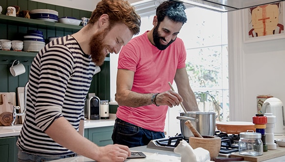 Two men cooking in the kitchen as a way to manage their anxiety