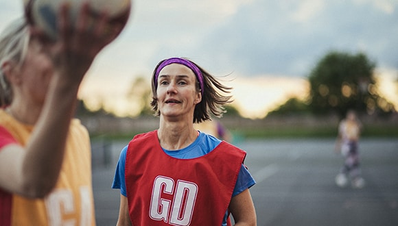 A woman playing netball