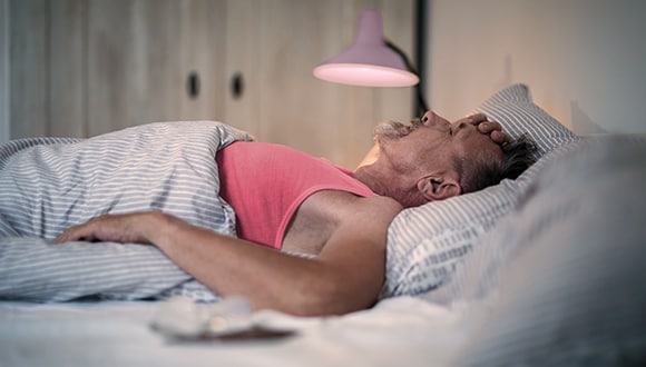 Man with sleep apnoea in bed