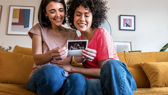 Pregnant couple on couch