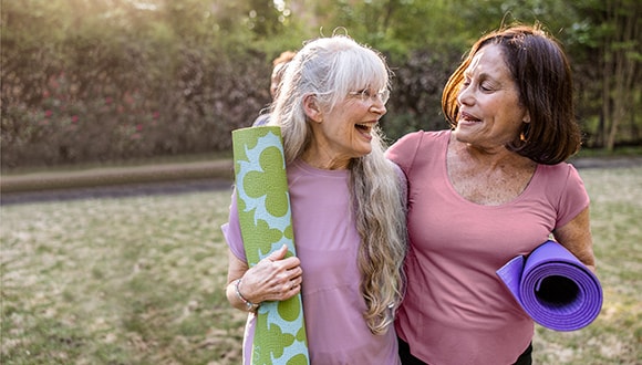 Two women in their 50s exercising in a park