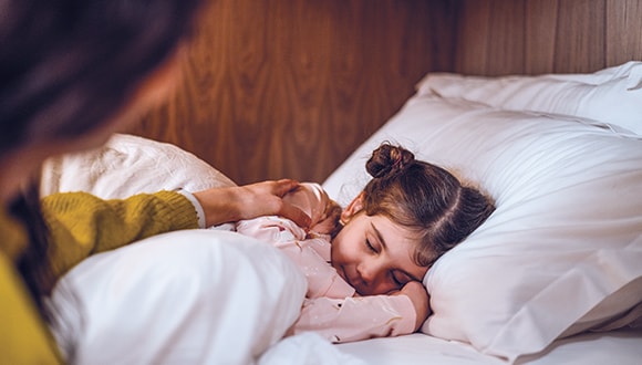 Little young sleeping in bed