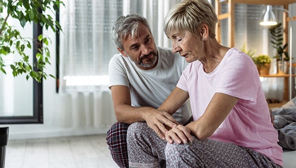 Lady looking down after having painful sex with partner