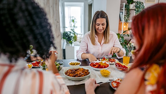 Women sitting at the table eating during the festive season