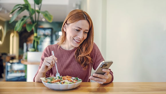 A woman eating a healthy meal to lower blood pressure