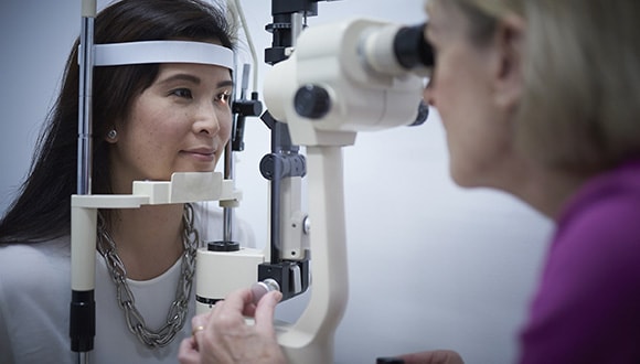 Lady getting her eyes checked to help prevent myopia