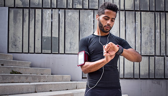 Man checking his device to monitor his heart rate