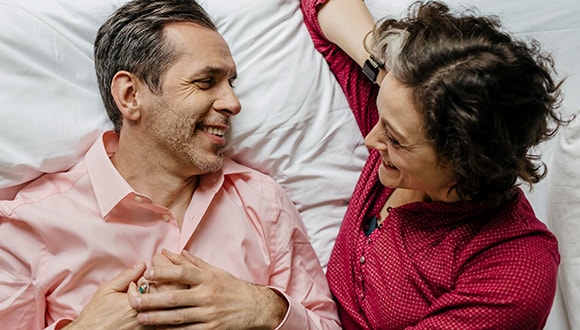 Man and woman laying in bed together