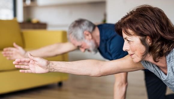 An older man and woman doing exercises