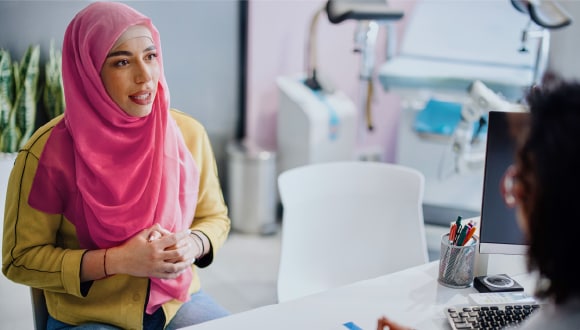 Girl sitting with a doctor learning about endometriosis symptoms and treatments