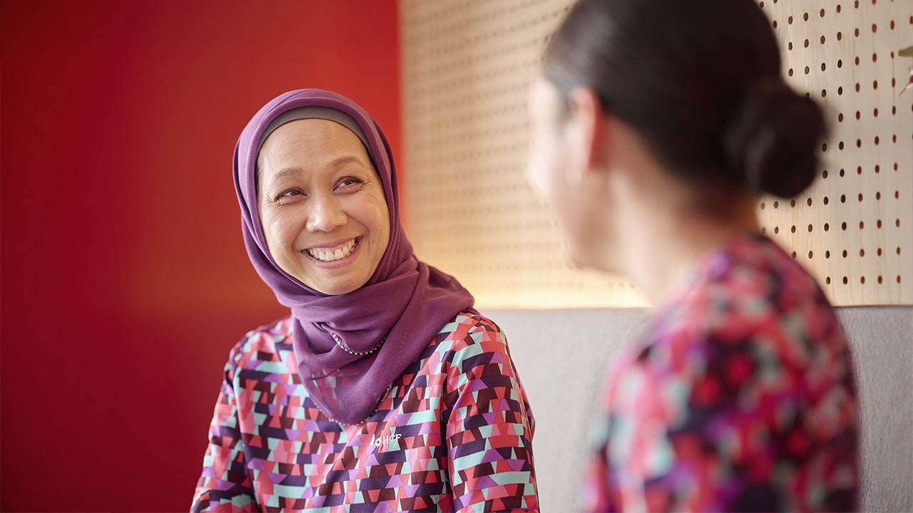 An HCF branch staff member laughing with a colleage. 