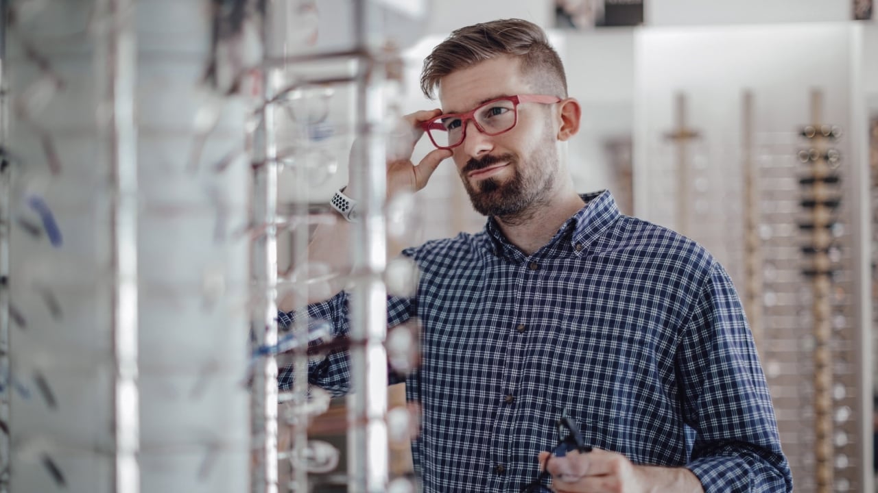 Man trying on glasses at an eyecare centre.