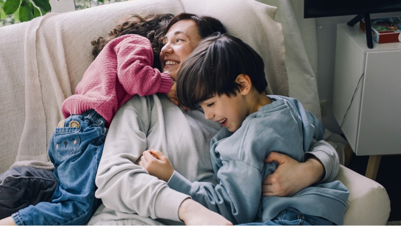 Mum playing with her children, a son and daughter.