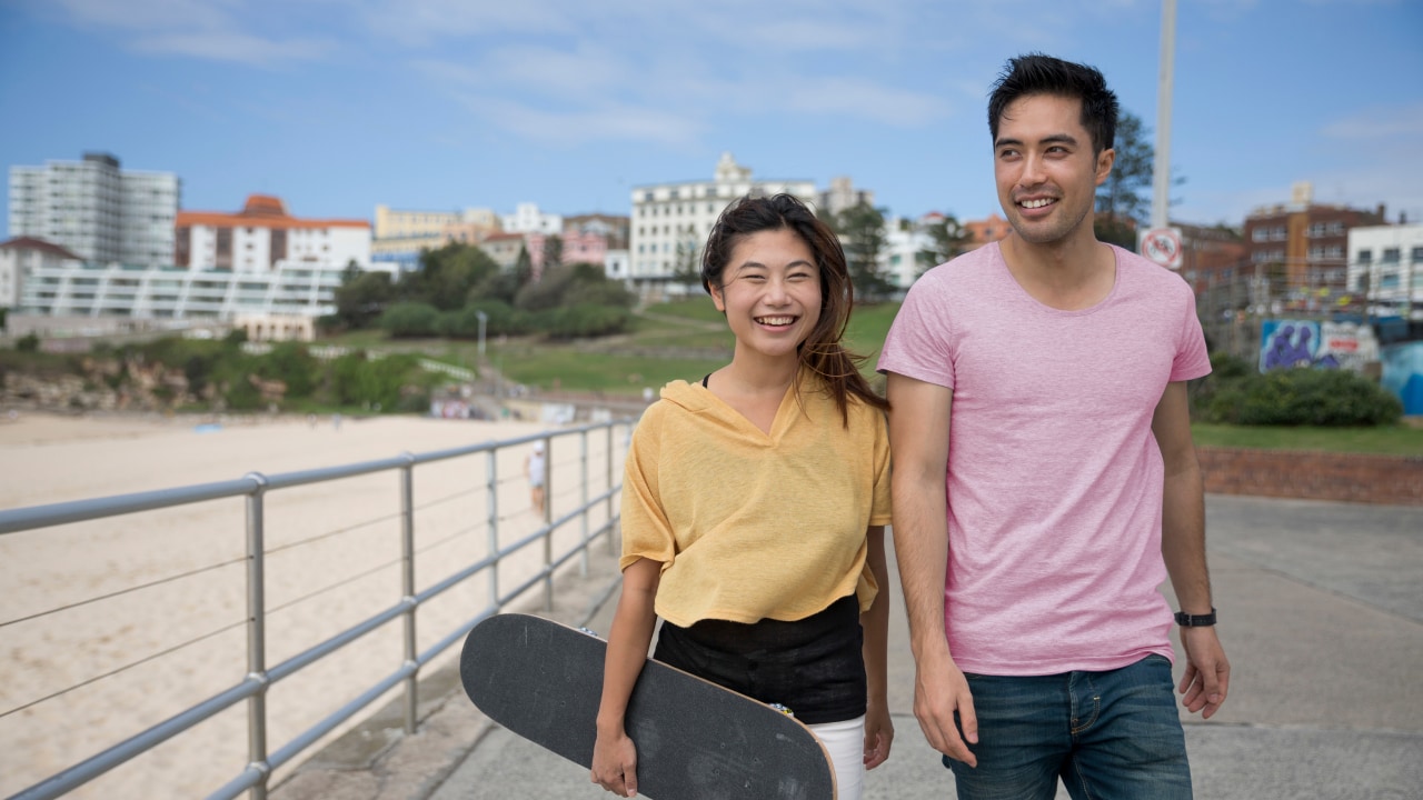 Young international travellers on visa health cover enjoying the beach in Australia