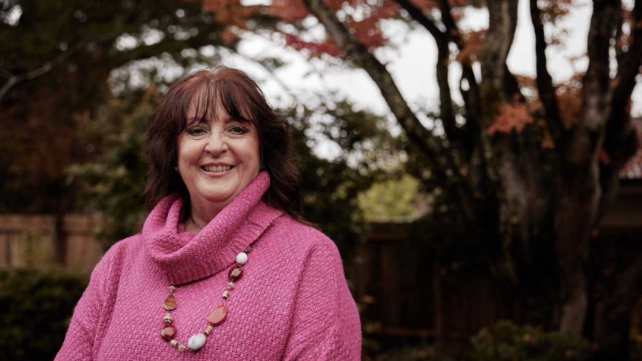 Woman smiling at the camera for a professional headshot.