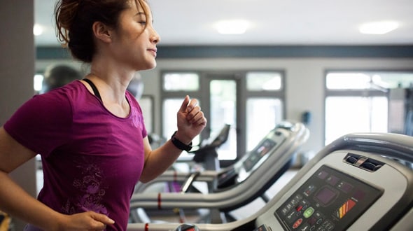 Photo of a female exercising on a treadmill