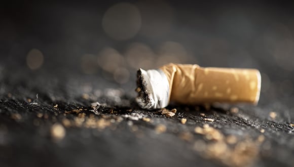 Photo of a used cigarette butt on the ground 