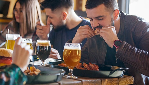 Man eating and drinking at a restaurant