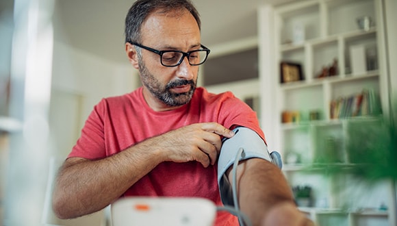 Man measuring his blood pressure for healthy ageing