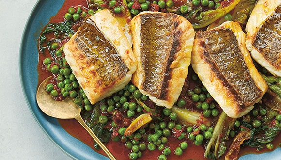 Crisp-skin snapper on a plate of peas