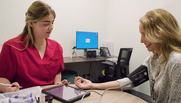 woman gettiing her blood pressure checked