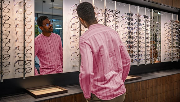 man choosing pair of glasses