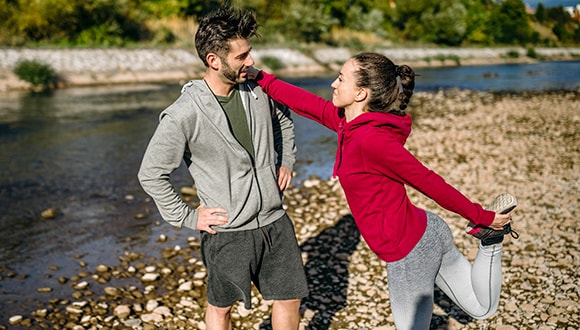 Couple exercising, using their extras cover