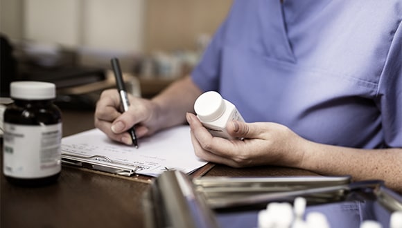 Man holding a bottle of medicine