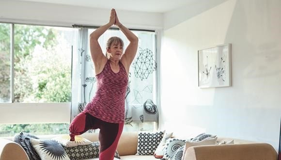 Woman practicing yoga to prevent burnout
