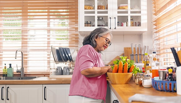 Women in the kitchen looking at fresh carrots