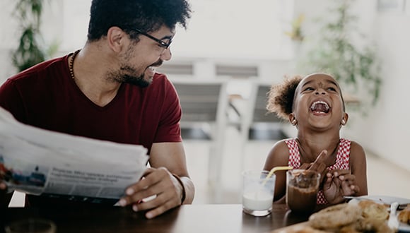 Dad and daughter eating breakfast