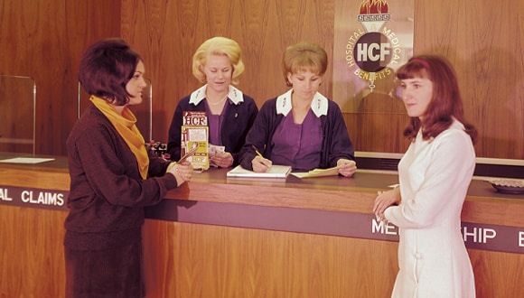 Archive shot of HCF staff members talking to a member