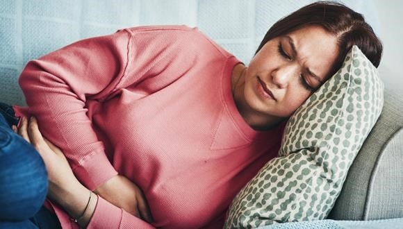 Woman with PCOS symptoms lying on couch