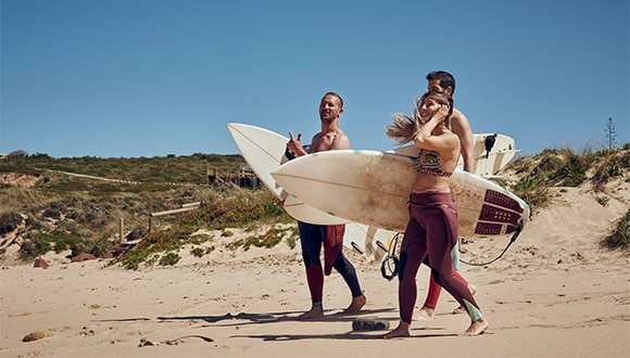 Friends on the beach after surfing